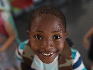 student looking up at the camera and smiling